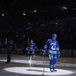 Vancouver Canucks' Daniel Sedin, front, and his twin brother, Henrik Sedin, both of Sweden, skate before playing in their last home NHL hockey game, against the Arizona Coyotes on Thursday, April 5, 2018, in Vancouver, British Columbia. (Darryl Dyck/The Canadian Press via AP)