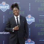 Central Florida's Shaquem Griffin poses for photos on the red carpet before the first round of the NFL football draft, Thursday, April 26, 2018, in Arlington, Texas. (AP Photo/Eric Gay)