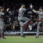 Arizona Diamondbacks relief pitcher Archie Bradley, center, outfielder David Peralta, right, and catcher Jeff Mathis, left, celebrate after a 2-1 win over the San Francisco Giants during a baseball game, Monday, April 9, 2018, in San Francisco. (AP Photo/Marcio Jose Sanchez)