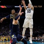 Villanova's Donte DiVincenzo (10) shoots a 3-point basket during the second half in the championship game of the Final Four NCAA college basketball tournament against Michigan, Monday, April 2, 2018, in San Antonio. (AP Photo/David J. Phillip)
