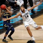 Michigan's Charles Matthews (1) drives the ball against Villanova's Omari Spellman (14) during the second half in the championship game of the Final Four NCAA college basketball tournament, Monday, April 2, 2018, in San Antonio. (AP Photo/Brynn Anderson)