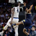 Villanova's Eric Paschall (4) shoots over Michigan's Zavier Simpson during the second half in the championship game of the Final Four NCAA college basketball tournament, Monday, April 2, 2018, in San Antonio. (AP Photo/David J. Phillip)