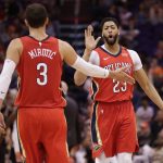 New Orleans Pelicans forward Anthony Davis (23) slaps hands with Nikola Mirotic (3) during the second half of the team's NBA basketball game against the Phoenix Suns on Friday, April 6, 2018, in Phoenix. (AP Photo/Matt York)