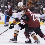 Anaheim Ducks' Ryan Getzlaf controls the puck as Phoenix Coyotes' Nick Cousins defends during the first period of an NHL hockey game Saturday, April 7, 2018, in Glendale, Ariz. (AP Photo/Darryl Webb)