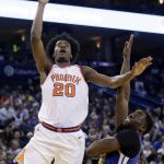 Phoenix Suns' Josh Jackson (20) shoots over Golden State Warriors' Draymond Green during the second half of an NBA basketball game Sunday, April 1, 2018, in Oakland, Calif. (AP Photo/Marcio Jose Sanchez)