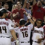 Arizona Diamondbacks' Chris Owings (16) high-fives teammate Ketel Marte (4) after hitting a game-tying, 3-run home run against the Los Angeles Dodgers during the ninth inning of a baseball game, Monday, April 2, 2018, in Phoenix. (AP Photo/Matt York)