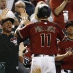 Arizona Diamondbacks' A.J. Pollock (11) celebrates his run scored against the San Diego Padres with Diamondbacks' David Peralta, left, and manager Torey Lovullo (17) during the fourth inning of a baseball game Sunday, April 22, 2018, in Phoenix. (AP Photo/Ross D. Franklin)
