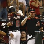 Arizona Diamondbacks' A.J. Pollock (11) celebrates his home run against the San Diego Padres with manager Torey Lovullo, right, during the third inning of a baseball game Saturday, April 21, 2018, in Phoenix. (AP Photo/Ross D. Franklin)