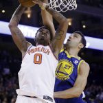 Golden State Warriors' Zaza Pachulia (27) blocks a shot from Phoenix Suns' Marquese Chriss (0) during the second half of an NBA basketball game Sunday, April 1, 2018, in Oakland, Calif. (AP Photo/Marcio Jose Sanchez)