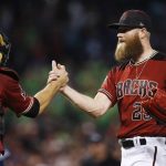 Arizona Diamondbacks relief pitcher Archie Bradley, right, celebrates with catcher Jeff Mathis, left, after the final out of a baseball game against the San Diego Padres Sunday, April 22, 2018, in Phoenix. The Diamondbacks defeated the Padres 4-2. (AP Photo/Ross D. Franklin)