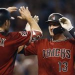 Arizona Diamondbacks' Nick Ahmed (13) celebrates his two-run home run against the San Diego Padres with A.J. Pollock (11) during the fourth inning of a baseball game Sunday, April 22, 2018, in Phoenix. (AP Photo/Ross D. Franklin)