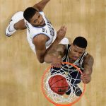Michigan's Charles Matthews (1) dunks past Villanova's Mikal Bridges during the second half in the championship game of the Final Four NCAA college basketball tournament, Monday, April 2, 2018, in San Antonio. (AP Photo/Eric Gay)