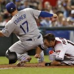 Arizona Diamondbacks' A.J. Pollock (11) is tagged out on a run-down by Los Angeles Dodgers' Kyle Farmer (17) during the sixth inning of a baseball game, Wednesday, April 4, 2018, in Phoenix. (AP Photo/Matt York)