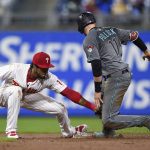 Arizona Diamondbacks' A.J. Pollock, right, slides safely past the tag of Philadelphia Phillies' Pedro Florimon to steal second base during the eighth inning of a baseball game, Tuesday, April 24, 2018, in Philadelphia. The Diamondbacks won 8-4. (AP Photo/Derik Hamilton)