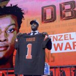 Ohio State's Denzel Ward poses with his Cleveland Browns jersey during the first round of the NFL football draft, Thursday, April 26, 2018, in Arlington, Texas. (AP Photo/David J. Phillip)