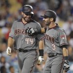 Arizona Diamondbacks' Daniel Descalso, right, celebrates his two-run home run with Paul Goldschmidt during the seventh inning of the team's baseball game against the Los Angeles Dodgers, Friday, April 13, 2018, in Los Angeles. (AP Photo/Jae C. Hong)