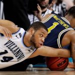 Villanova forward Omari Spellman (14) fights for a loose ball with Michigan guard Charles Matthews during the second half in the championship game of the Final Four NCAA college basketball tournament, Monday, April 2, 2018, in San Antonio. (AP Photo/Eric Gay)
