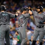 Arizona Diamondbacks' Deven Marrero, right, is congratulated by Alex Avila, left, and Chris Owings after hitting a three-run home run during the fourth inning of a baseball game against the Los Angeles Dodgers, Saturday, April 14, 2018, in Los Angeles. (AP Photo/Mark J. Terrill)