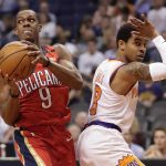 New Orleans Pelicans guard Rajon Rondo (9) looks to pass as Phoenix Suns guard Tyler Ulis (8) defends during the first half of an NBA basketball game Friday, April 6, 2018, in Phoenix. (AP Photo/Matt York)