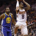 Phoenix Suns guard Tyler Ulis (8) drives past Golden State Warriors forward Kevin Durant in the second half during an NBA basketball game, Sunday, April 8, 2018, in Phoenix. The Warriors defeated the Suns 117-100. (AP Photo/Rick Scuteri)