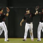 Arizona Diamondbacks left fielder David Peralta (6), center fielder A.J. Pollock, center, and right fielder Chris Owings (16) celebrate a win over the San Diego Padres after the final out of the ninth inning of a baseball game Saturday, April 21, 2018, in Phoenix. AP Photo/Ross D. Franklin)