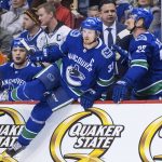 Vancouver Canucks' Henrik Sedin (33) and his twin brother, Daniel Sedin (22), both of Sweden, come off the bench and onto the ice during the first period of an NHL hockey game against the Arizona Coyotes on Thursday, April 5, 2018, in Vancouver, British Columbia. (Darryl Dyck/The Canadian Press via AP)