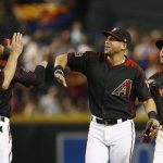 Arizona Diamondbacks' Paul Goldschmidt (44), Deven Marrero, second from left, David Peralta, second from right, and Chris Owings, right, exchange high-fives after the ninth inning of a baseball game against the San Diego Padres, Saturday, April 21, 2018, in Phoenix. (AP Photo/Ross D. Franklin)