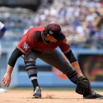 Arizona Diamondbacks starting pitcher Zack Godley, right, cannot handle a ball hit for a single by Los Angeles Dodgers' Cody Bellinger as Matt Kemp, left, advances to second during the third inning of a baseball game Sunday, April 15, 2018, in Los Angeles. (AP Photo/Mark J. Terrill)