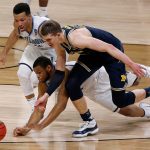 Villanova's Jalen Brunson, left, Omari Spellman and Michigan's Moritz Wagner chase the loose ball during the first half in the championship game of the Final Four NCAA college basketball tournament, Monday, April 2, 2018, in San Antonio. (AP Photo/Brynn Anderson)