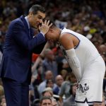 Villanova head coach Jay Wright hugs Phil Booth as they celebrate after the championship game of the Final Four NCAA college basketball tournament against Michigan, Monday, April 2, 2018, in San Antonio. Villanova won 79-62. (AP Photo/David J. Phillip)