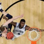 Michigan's Moritz Wagner (13) shoots over Villanova's Eric Paschall (4) during the second half in the championship game of the Final Four NCAA college basketball tournament, Monday, April 2, 2018, in San Antonio. (AP Photo/Eric Gay)