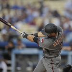Arizona Diamondbacks' Daniel Descalso hits an RBI single during the first inning of the team's baseball game against the Los Angeles Dodgers, Friday, April 13, 2018, in Los Angeles. (AP Photo/Jae C. Hong)