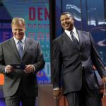 NFL Commissioner Roger Goodell and former player Stephen Atwater walk off the stage after announcing SMU's Courtland Sutton as the Denver Broncos pick during the second round of the NFL football draft, Friday, April 27, 2018, in Arlington, Texas. (AP Photo/Eric Gay)