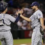 San Diego Padres relief pitcher Brad Hand, right, greets catcher Austin Hedges after the team's 4-1 win in a baseball game against the Arizona Diamondbacks on Friday, April 20, 2018, in Phoenix. (AP Photo/Matt York)