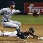 Arizona Diamondbacks' Chris Owings, right, dives safely back to first base as San Diego Padres relief pitcher Adam Cimber, left, reaches out for a late throw during the sixth inning of a baseball game Saturday, April 21, 2018, in Phoenix. (AP Photo/Ross D. Franklin)