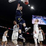 Michigan's Moritz Wagner (13) dunks during the second half in the championship game of the Final Four NCAA college basketball tournament against Villanova, Monday, April 2, 2018, in San Antonio. (AP Photo/Eric Gay)