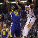 Golden State Warriors forward Kevon Looney (5) drives on Phoenix Suns forward Danuel House Jr. in the first half during an NBA basketball game, Sunday, April 8, 2018, in Phoenix. (AP Photo/Rick Scuteri)