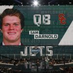 USC's Sam Darnold is shown on the video screen as he is greeted on stage by Commissioner Roger Goodell after being picked by the New York Jets during the first round of the NFL football draft, Thursday, April 26, 2018, in Arlington, Texas. (AP Photo/David J. Phillip)