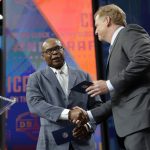 Prof Football Hall of Famer Mike Singletary, left, greets NFL Commissioner Roger Goodell as Singletary announces the Chicago Bears' pick during the second round of the NFL football draft Friday, April 27, 2018, in Arlington, Texas. The Bears selected Iowa's James Daniels. (AP Photo/Eric Gay)
