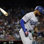 Los Angeles Dodgers' Matt Kemp tosses his bat after drawing a walk against the Arizona Diamondbacks in the eighth inning of a baseball game Wednesday, April 4, 2018, in Phoenix. Kemp was the only Dodger to get a hit in the Diamondbacks 3-0 win. (AP Photo/Matt York)