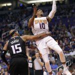 Phoenix Suns guard Shaquille Harrison (10) shoots asSacramento Kings guard Vince Carter (15) holds him back during the second half of an NBA basketball game Tuesday, April 3, 2018, in Phoenix. (AP Photo/Matt York)