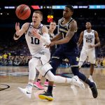 Villanova's Donte DiVincenzo (10) chases the loose ball against Michigan's Charles Matthews (1) during the second half in the championship game of the Final Four NCAA college basketball tournament, Monday, April 2, 2018, in San Antonio. (AP Photo/David J. Phillip)