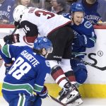 Arizona Coyotes' Zac Rinaldo (34) checks Vancouver Canucks' Brendan Leipsic (9) during the second period of an NHL hockey game Thursday, April 5, 2018, in Vancouver, British Columbia. (Darryl Dyck/The Canadian Press via AP)