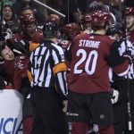 Phoenix Coyotes' Oliver Ekman-Larsson gets thrown into his own bench by an Anaheim Ducks player during the first period of an NHL hockey game Saturday, April. 7, 2018, in Glendale, Ariz. (AP Photo/Darryl Webb)