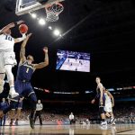 Villanova's Donte DiVincenzo (10) goes up for a shot over Michigan's Charles Matthews (1) during the second half in the championship game of the Final Four NCAA college basketball tournament, Monday, April 2, 2018, in San Antonio. (AP Photo/David J. Phillip)