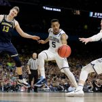 Villanova's Phil Booth (5) and Donte DiVincenzo (10) chase the loose ball as Michigan's Moritz Wagner (13) watches during the second half in the championship game of the Final Four NCAA college basketball tournament, Monday, April 2, 2018, in San Antonio. (AP Photo/Eric Gay)