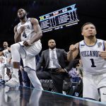 Villanova's Jalen Brunson (1), Eric Paschall (4) and players on Villanova bench react to a 3-point basket during the second half in the championship game of the Final Four NCAA college basketball tournament against Michigan, Monday, April 2, 2018, in San Antonio. (AP Photo/David J. Phillip)