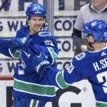 Vancouver Canucks' Daniel Sedin, left, celebrates his goal with his twin brother, Henrik Sedin, both of Sweden, against the Arizona Coyotes during the second period of an NHL hockey game Thursday, April 5, 2018, in Vancouver, British Columbia. (Darryl Dyck//The Canadian Press via AP)