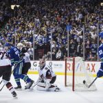 Vancouver Canucks' Alexander Edler (23), and Henrik Sedin (33) and Arizona Coyotes' Oliver Ekman-Larsson (23), all of Sweden, and Luke Schenn (2) watch as Coyotes goalie Darcy Kuemper allows the winning goal to Daniel Sedin, not shown, during overtime of an NHL hockey game Thursday, April 5, 2018, in Vancouver, British Columbia. (Darryl Dyck//The Canadian Press via AP)