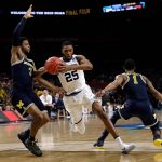 Villanova guard Mikal Bridges (25) drives to the basket between Michigan's Zavier Simpson, left, and Charles Matthews, right, during the second half in the championship game of the Final Four NCAA college basketball tournament, Monday, April 2, 2018, in San Antonio. (AP Photo/David J. Phillip)